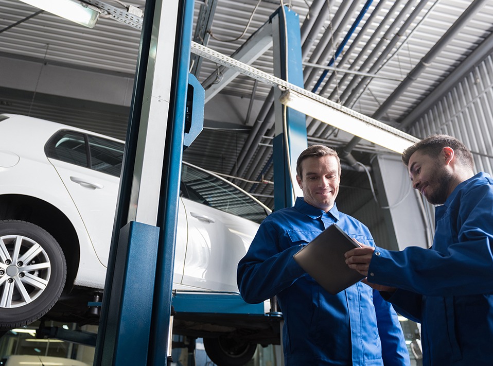Mechanics both inspecting a service checklist -Vehicle Servicing Mossley